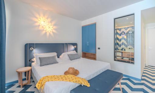 Modern room with blue decor and geometric patterns.