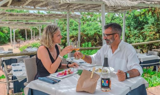 Couple toasting at an outdoor lunch in an elegant restaurant.