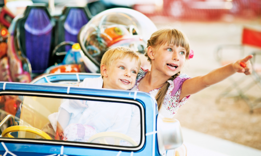 Happy kids on a ride, laughter and fun.