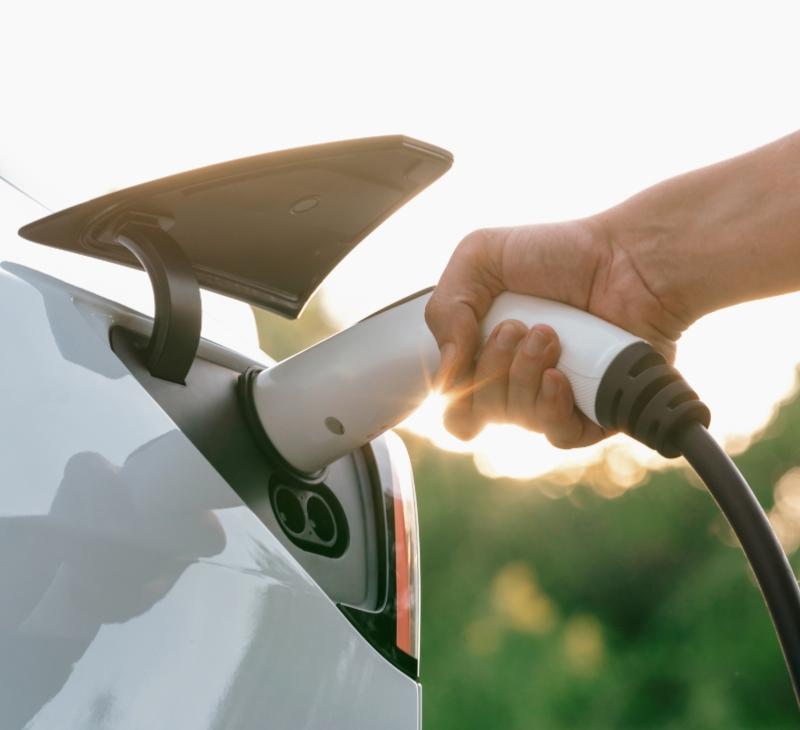 Charging an electric car with a cable.