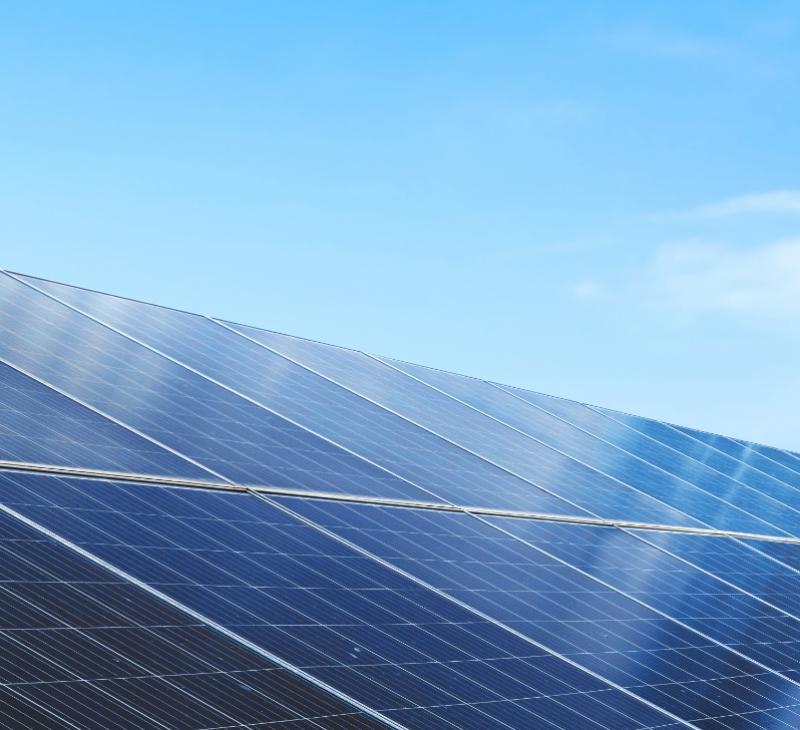 Solar panels under a blue sky.